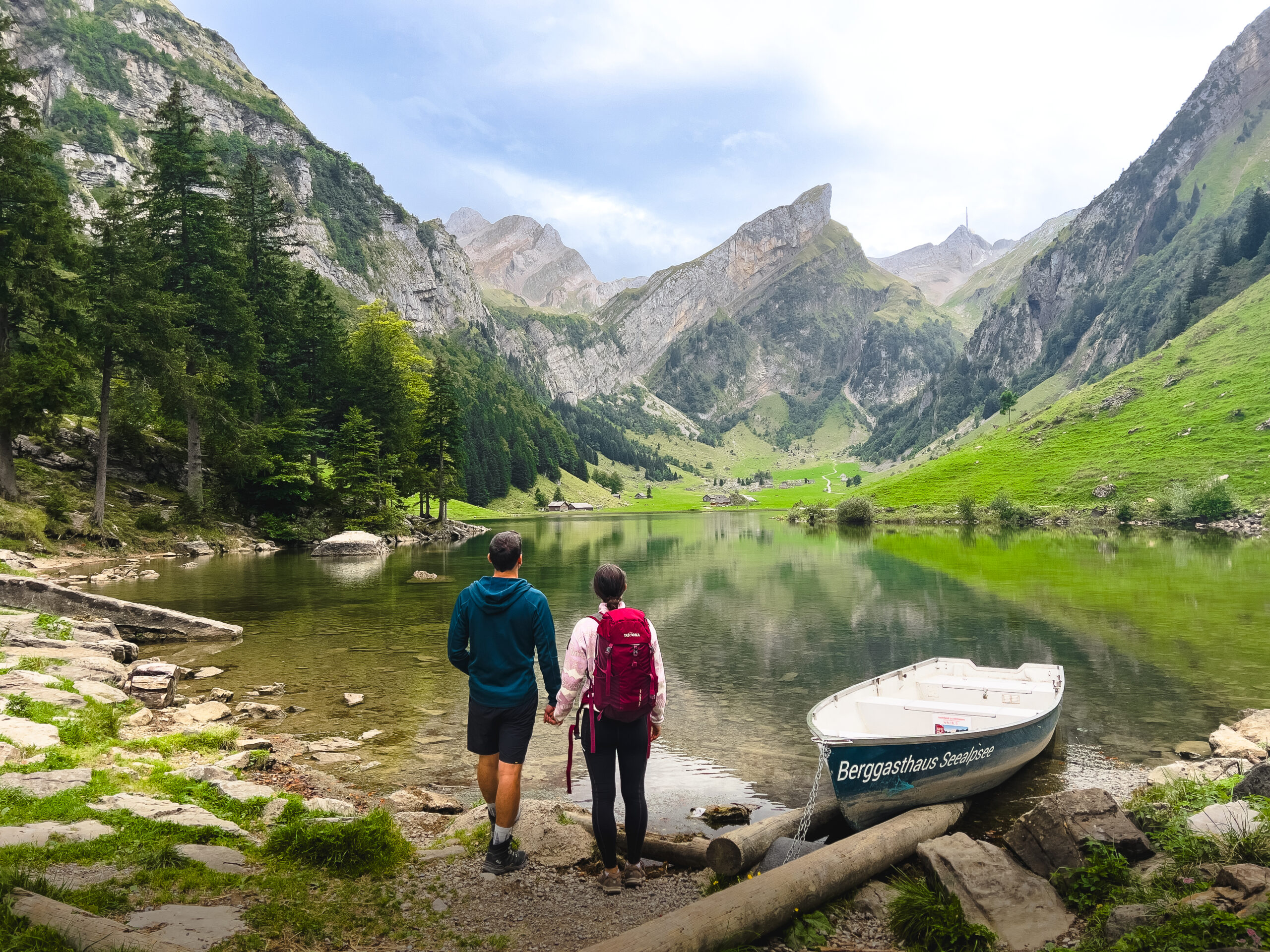 Pärchen hält Hände und steht vor dem Seealpsee in der Schweiz